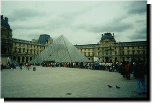 A long line of tourists at the entrance to the Louvre.