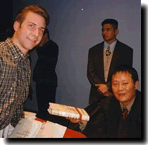 Wei Jinsheng signs a copy of his book for me.